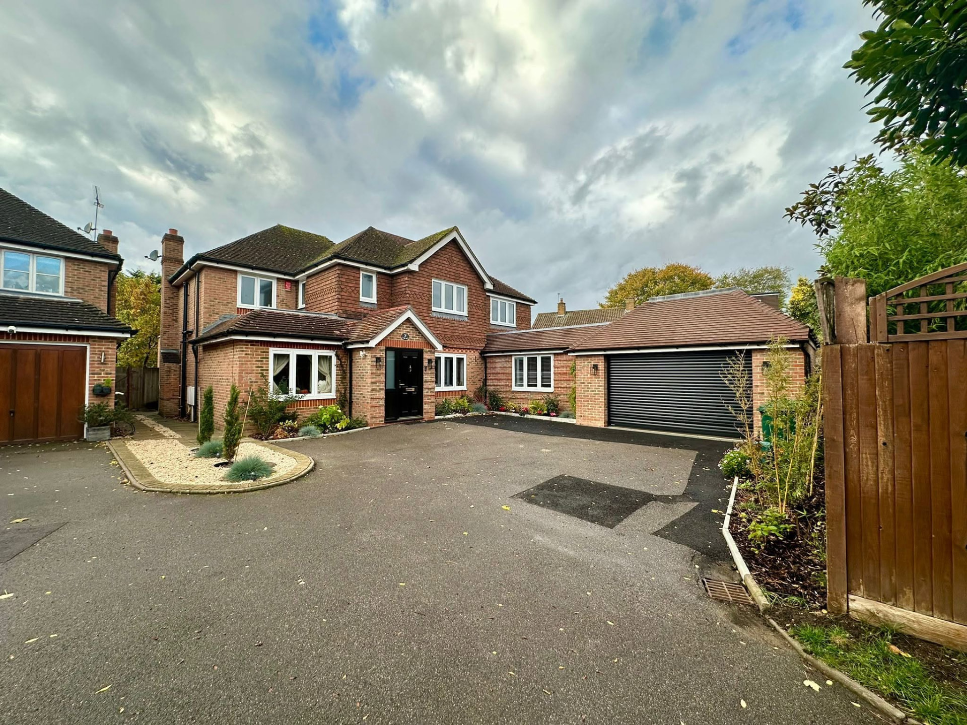 Completed new build brick house with a wide asphalt driveway