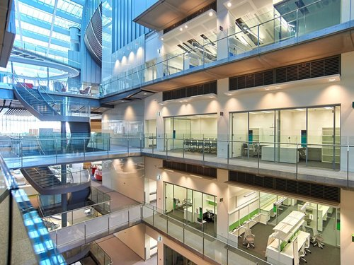 Multi-storey commercial atrium with glazed offices and steel walkways