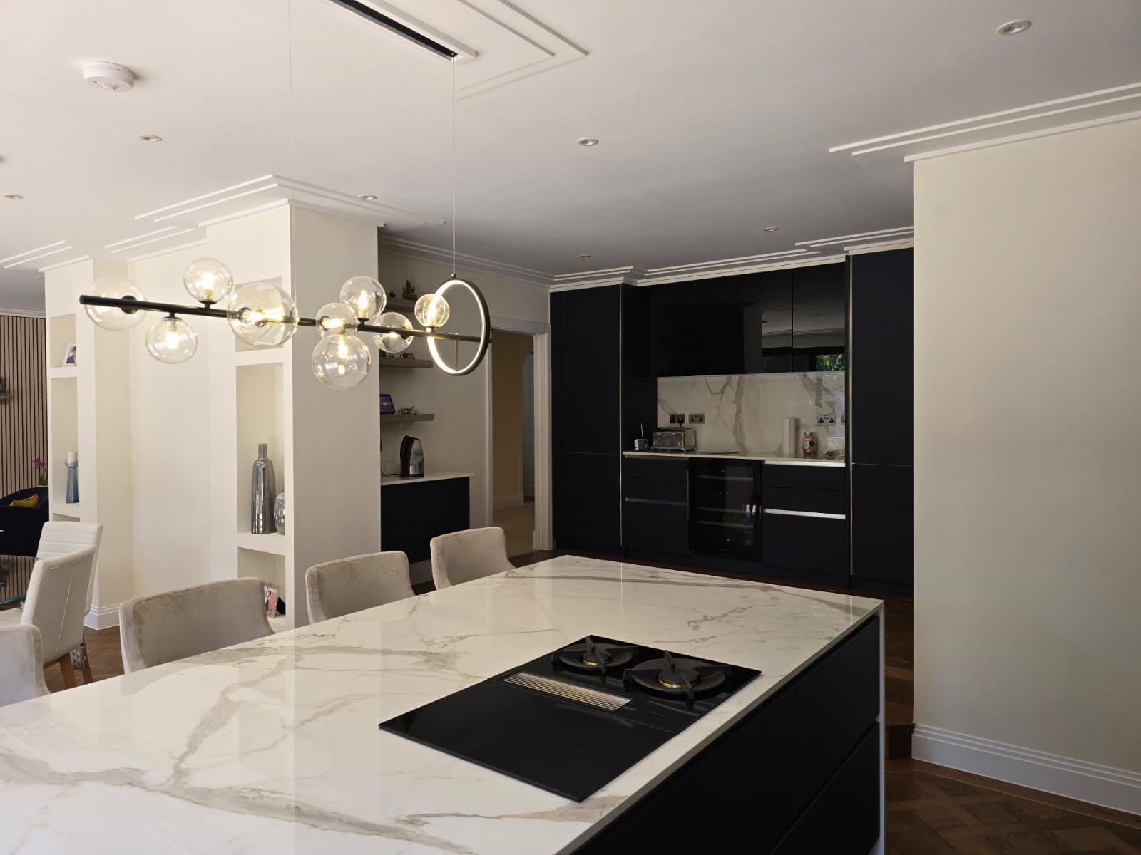 Kitchen extension with white marble worktops and matt black cabinetry